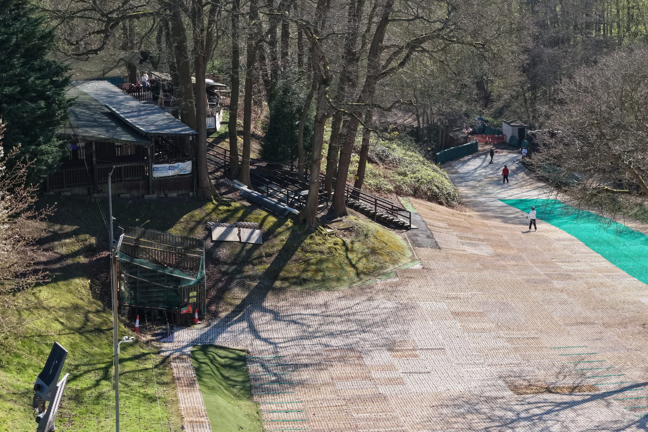 Aerial view of an outdoor activity slope surrounded by woodland